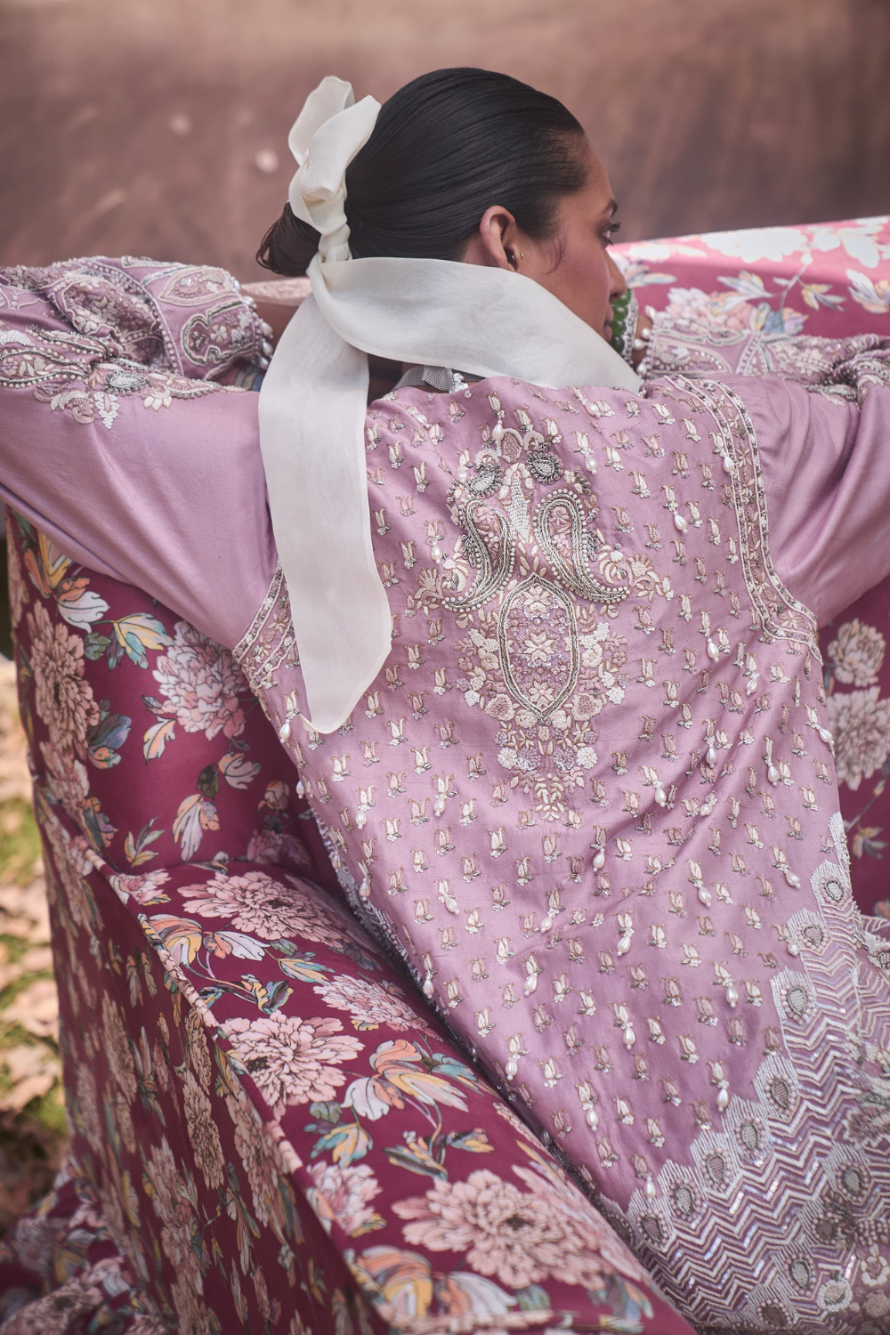 PELLE PINK EMBROIDERED JACKET PAIRED WITH A CLASSIC WHITE SAREE